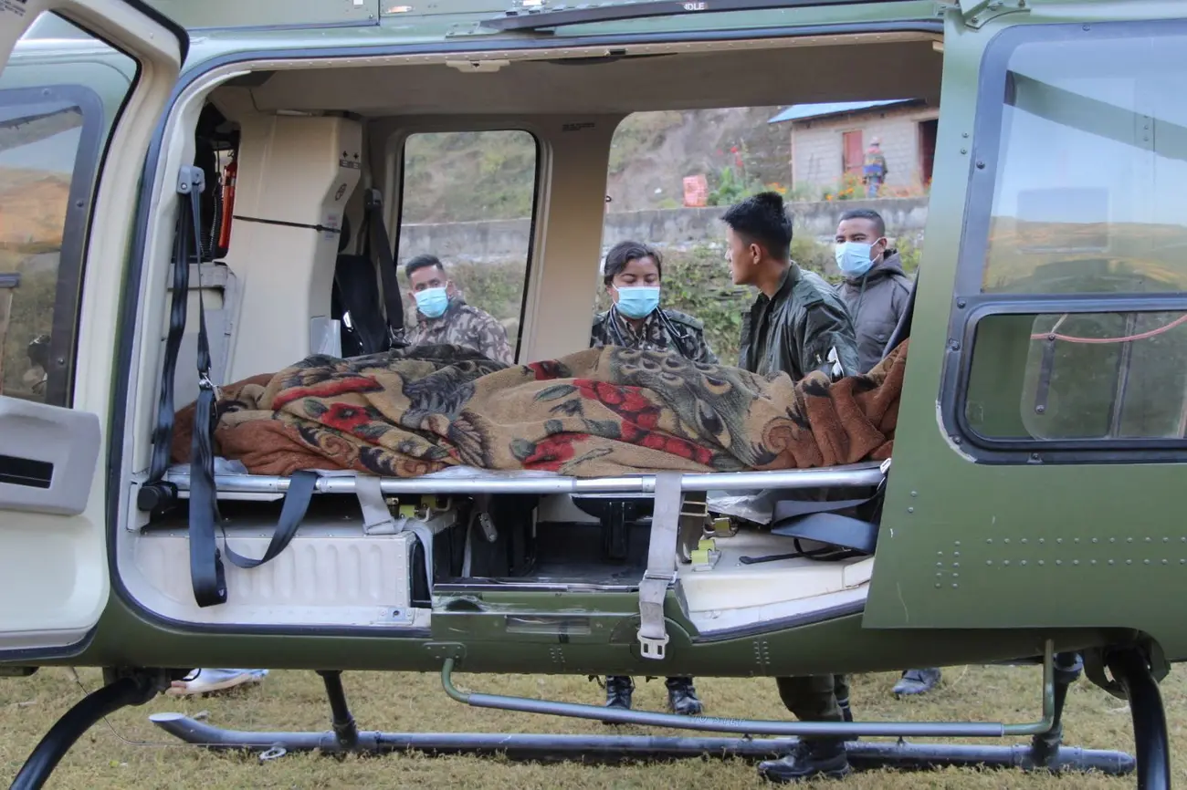 An injured person is seen inside a helicopter after an earthquake in Jajarkot
